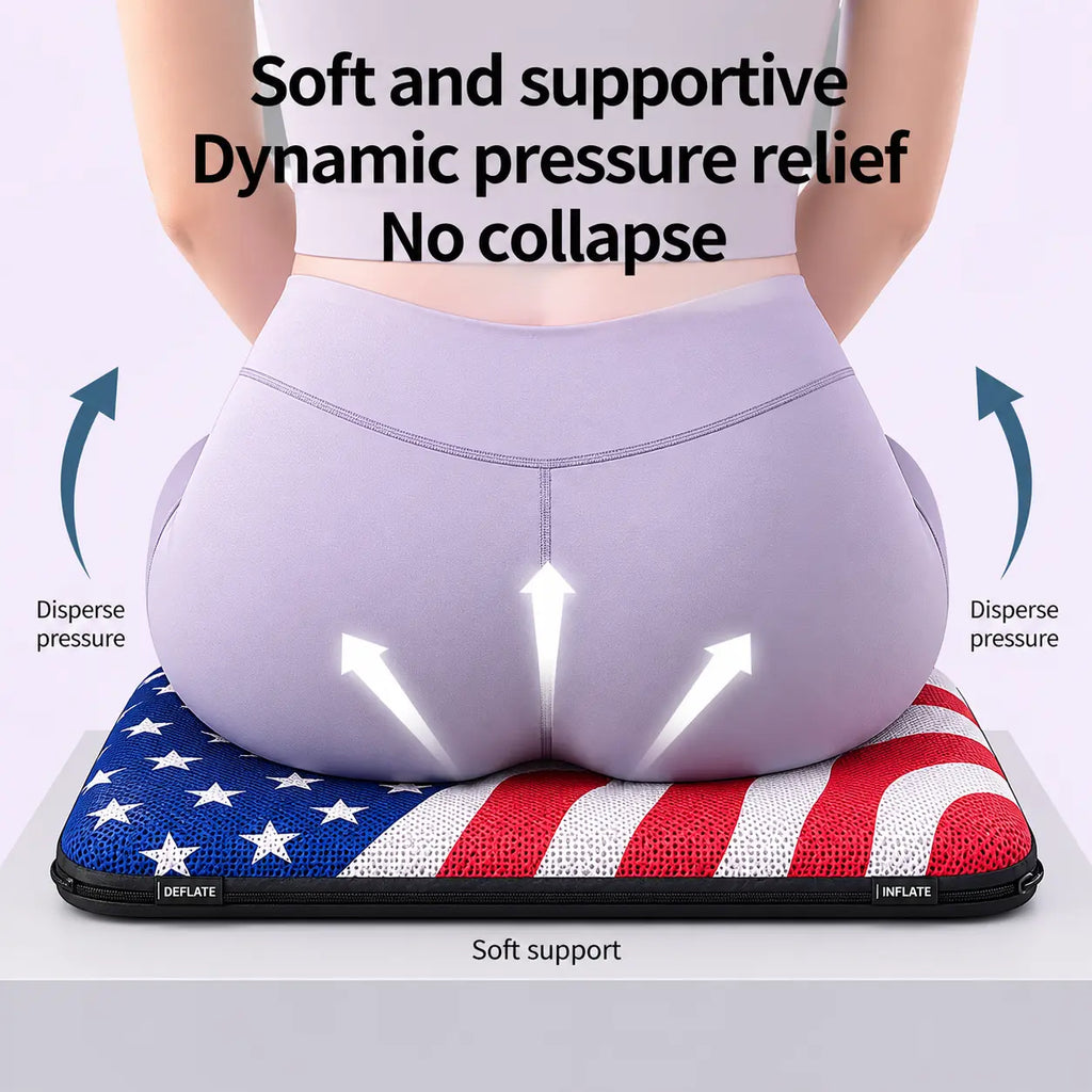 A promotional product infographic diagram demonstrating pelvic weight distribution on an ergonomic air seat cushion. Viewed from behind, a woman wearing light purple athletic leggings sits on a patriotic American flag themed cushion featuring white stars over a rich blue field on the left and wavy red and white stripes on the right. Three white arrows point upward on her lower body to illustrate "Soft support," while blue curved arrows on both sides point outward, labeled "Disperse pressure." Prominent blac